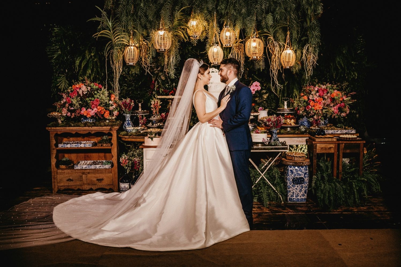 wedding couple in attire against maximalist wedding backdrop